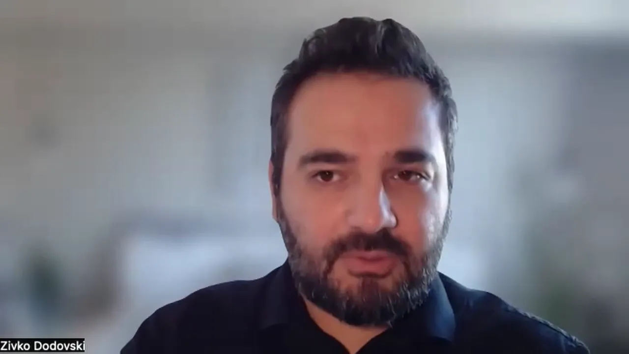 Well‑framed video screenshot of a speaker in a virtual presentation, clear and centered.