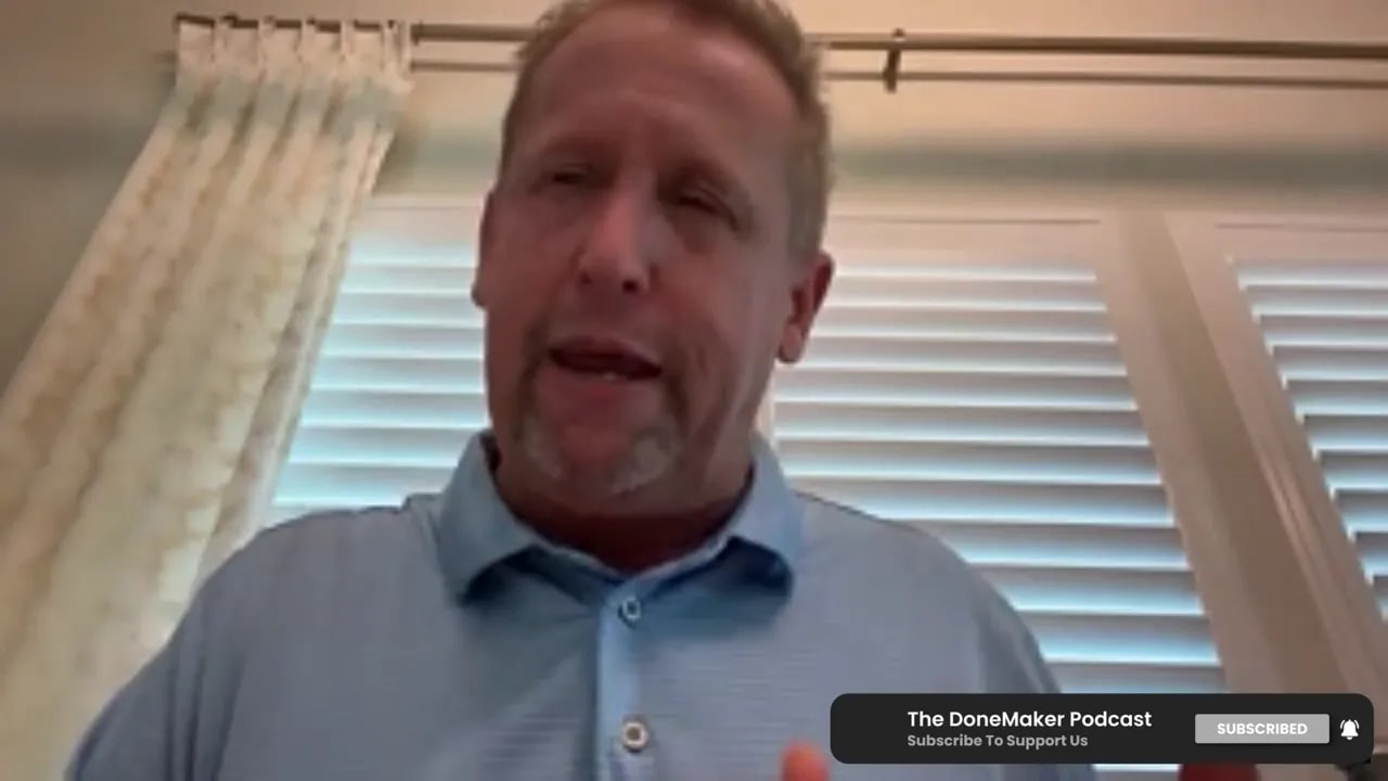 Podcast speaker on a video call framed from chest up with window blinds behind him and a 'The DoneMaker Podcast' subscribe overlay.