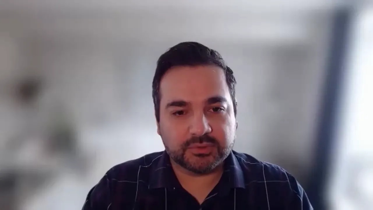 frontal portrait of speaker with blurred light background, speaking on camera