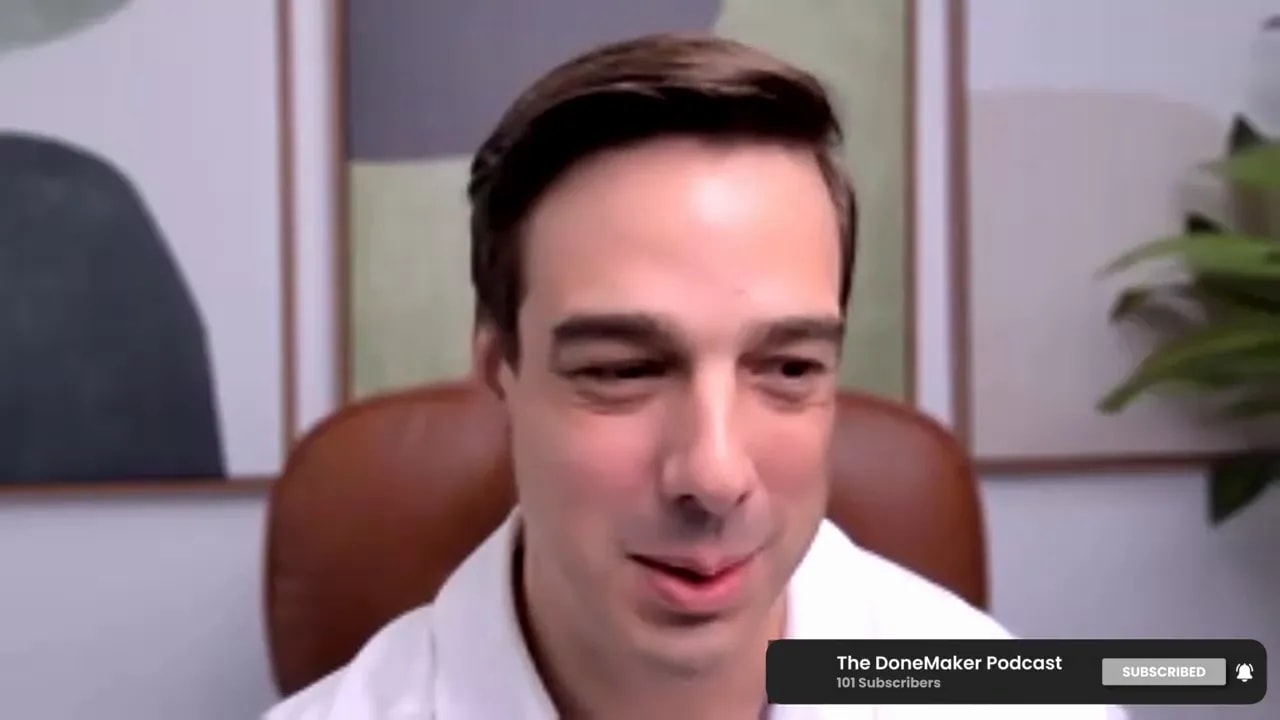 Podcast host on video call with a thoughtful expression, ideal for M&A integration discussion