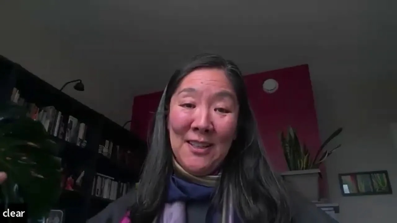 video screenshot of a leader smiling and gesturing during a home-office call