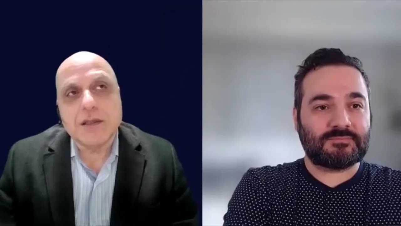 Video interview frame showing two men discussing using AI consciously and improving business leverage