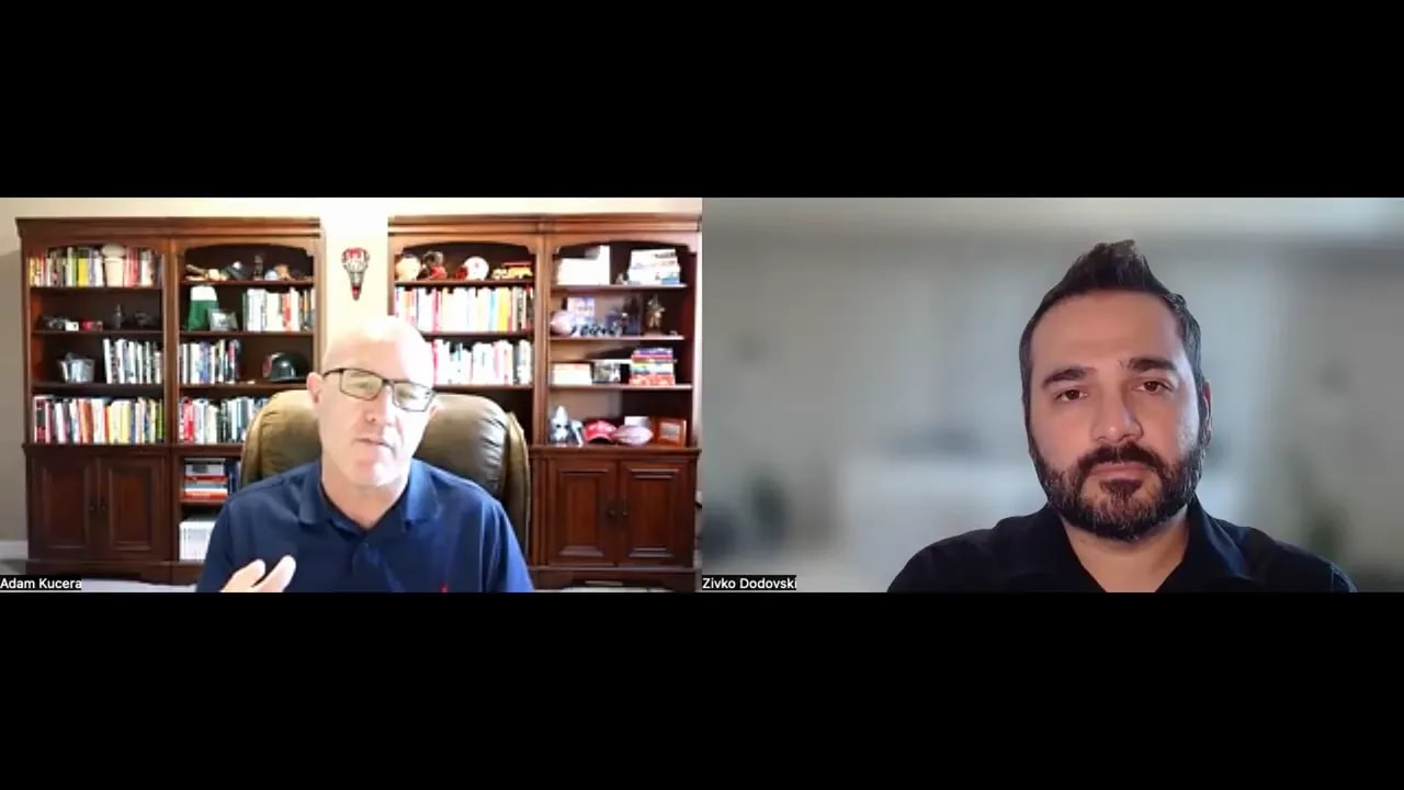 Two speakers on a split-screen video call; left participant gestures while explaining, right participant listens with a blurred background.