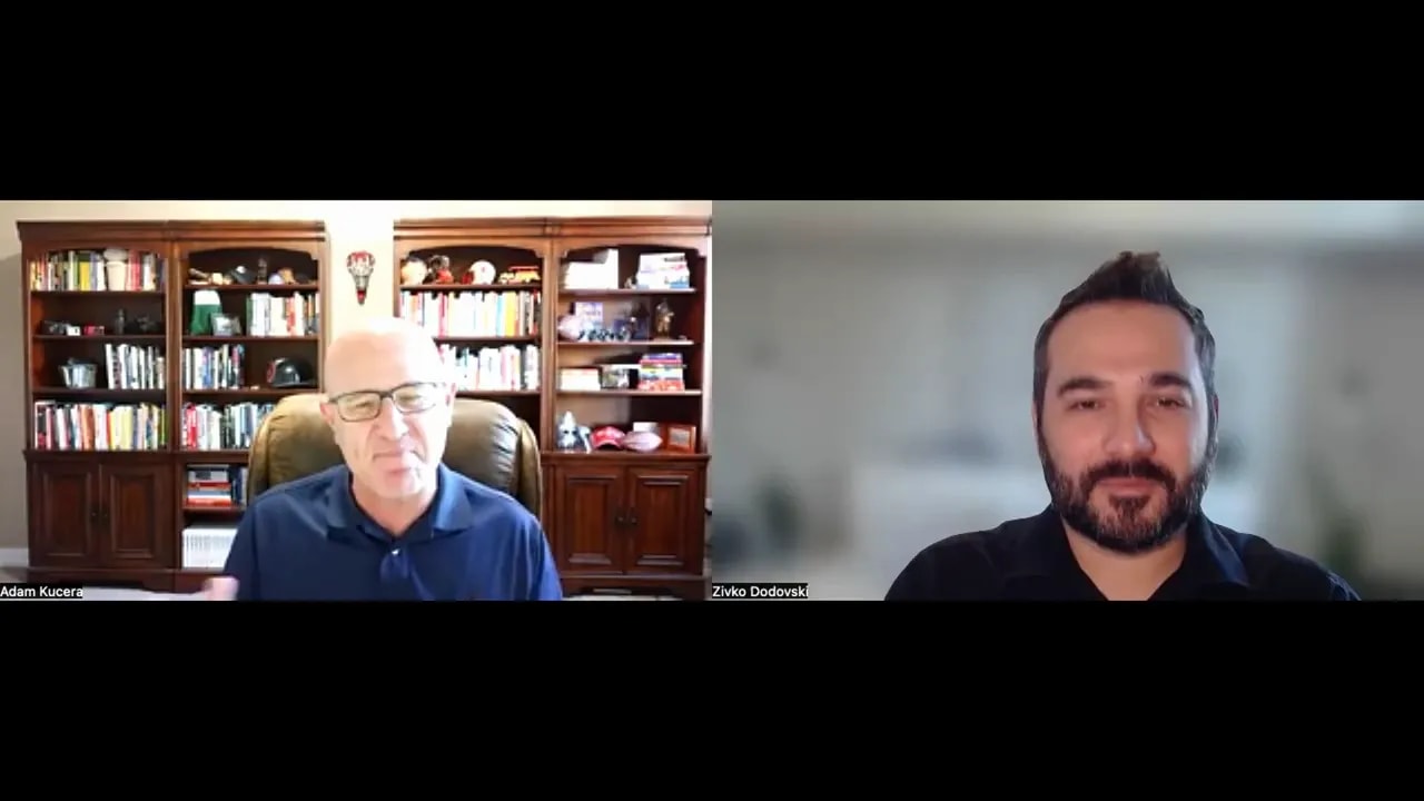 Two hosts on a virtual meeting, one gesturing while the other listens, illustrating a operational discussion.